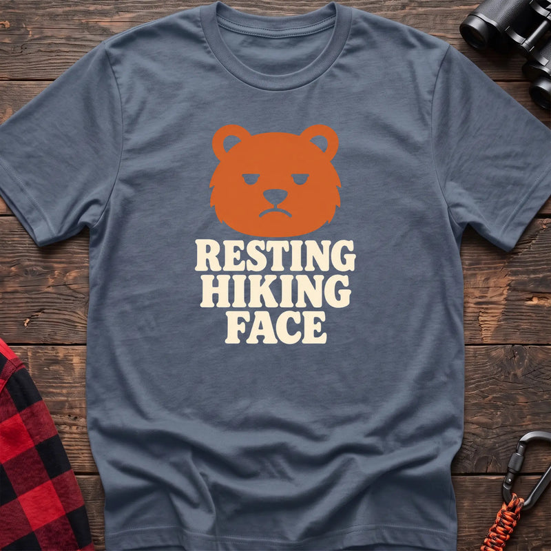 Stone blue cotton t-shirt with a grumpy bear graphic and Resting Hiking Face text on rustic wood
