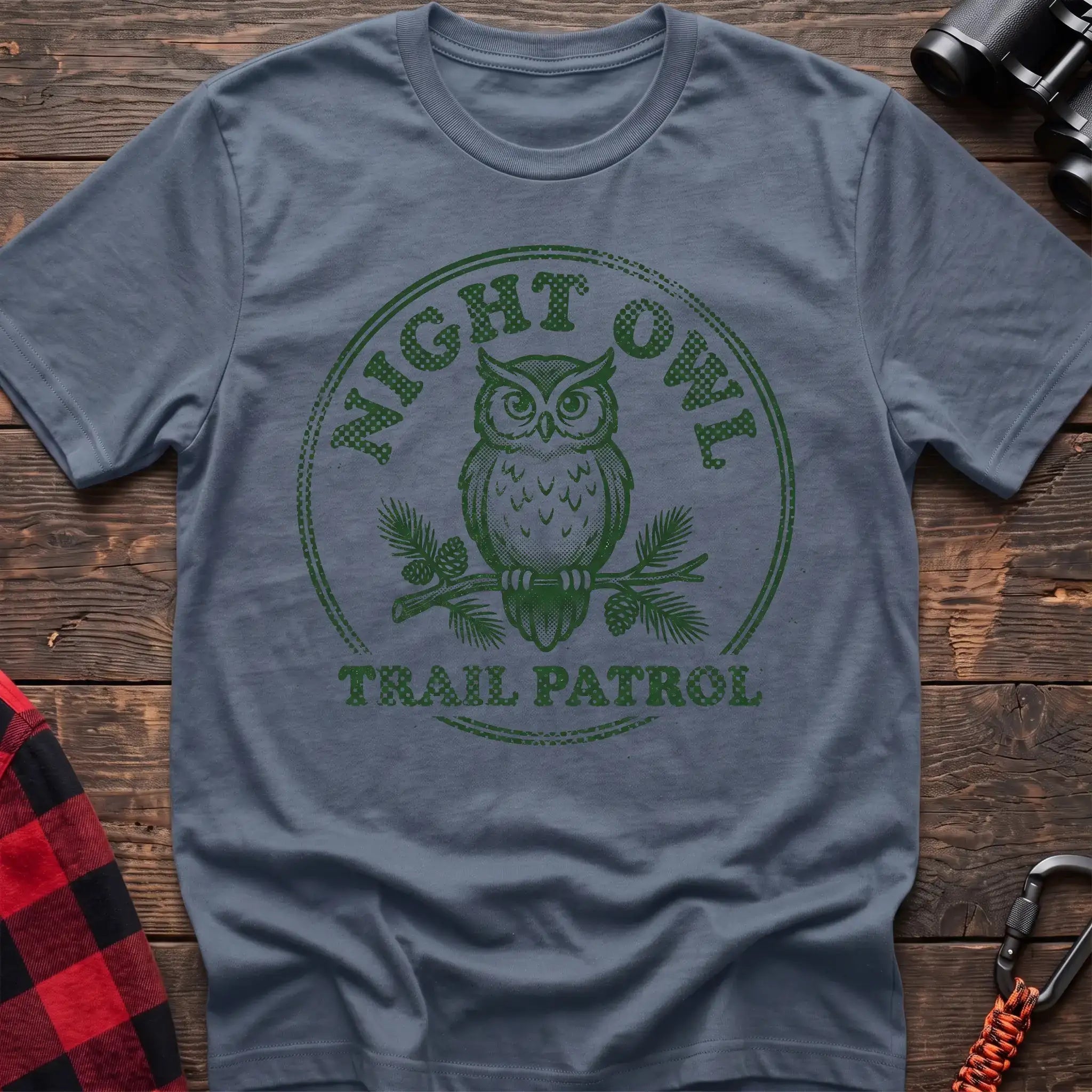 Stone blue t-shirt with green owl on a pine branch graphic and the text Night Owl Trail Patrol