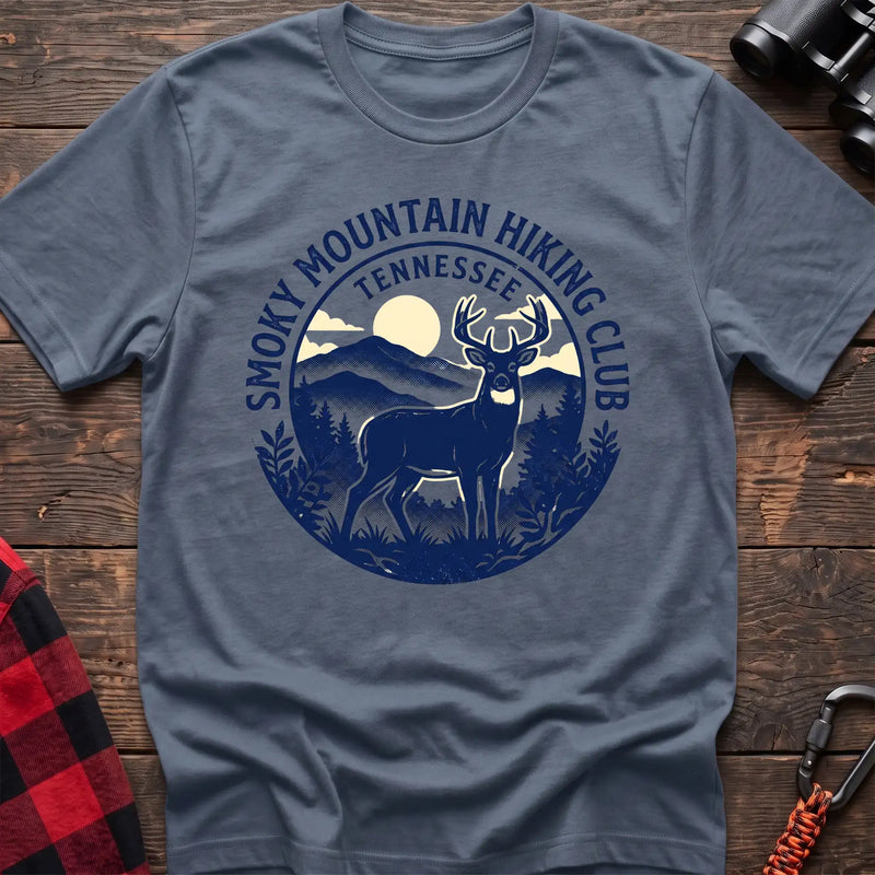 Stone blue t-shirt with circular badge graphic of a deer in the mountains reading Smoky Mountain Hiking Club Tennessee