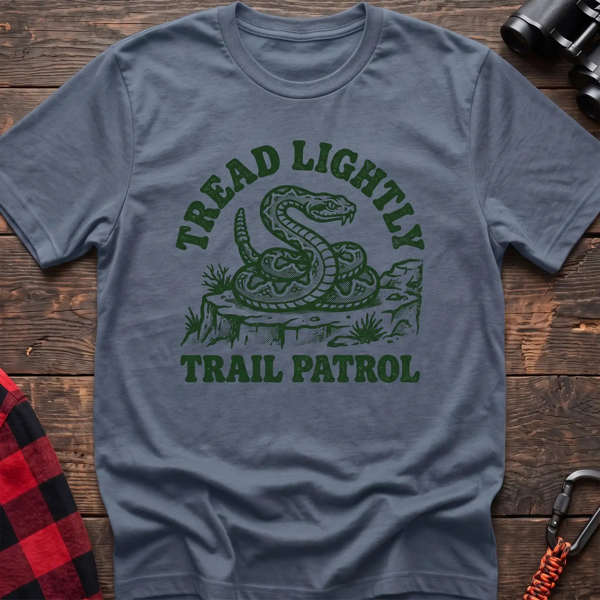 Stone blue t-shirt with dark green rattlesnake illustration and the text Tread Lightly Trail Patrol