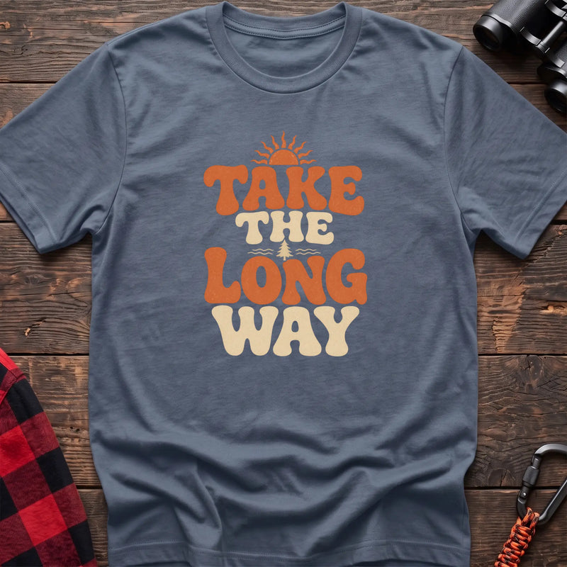 Stone blue cotton t-shirt with retro wavy text and Take the Long Way lettering on rustic wood