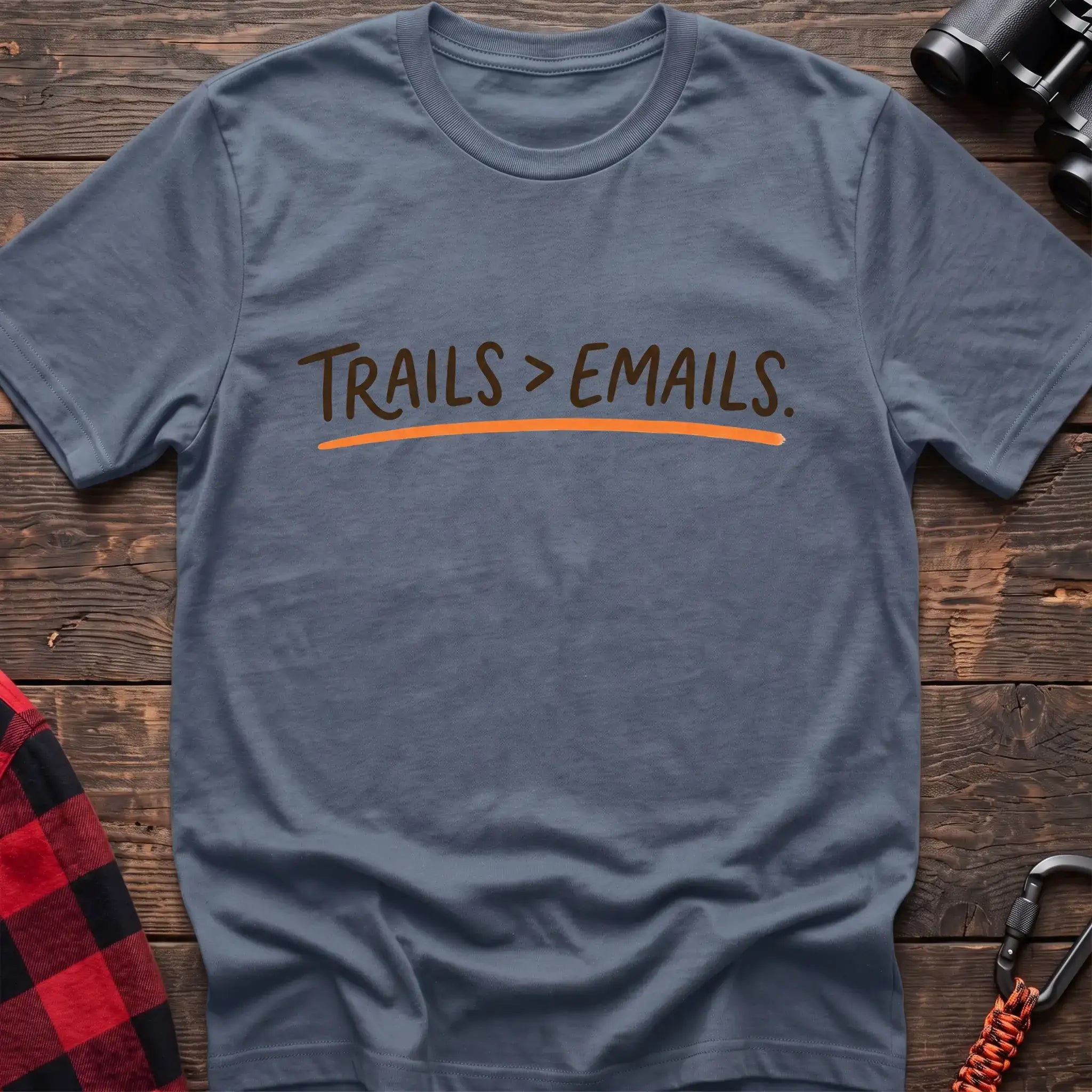 Stone blue t-shirt with brown handwritten-style text reading Trails greater than Emails and an orange underline