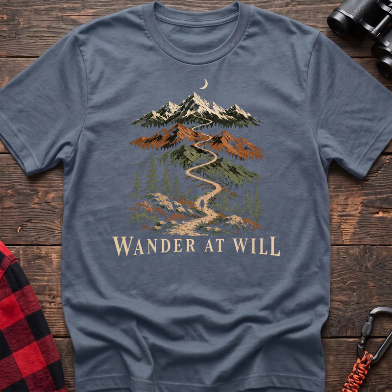 Stone blue cotton t-shirt with a mountain trail graphic and Wander at Will text on rustic wood