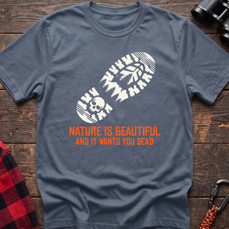 Stone blue t-shirt with white boot print graphic featuring a skull and pine trees, and orange text reading Nature Is Beautiful And It Wants You Dead