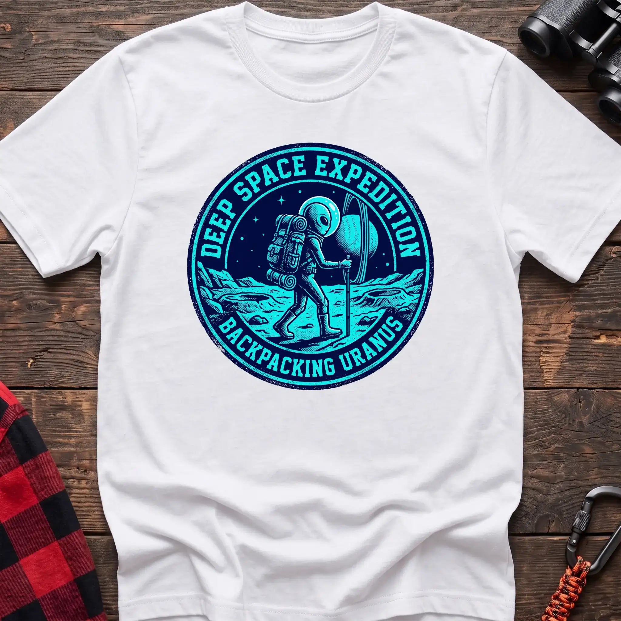 White t-shirt with circular badge graphic of an alien backpacking on Uranus, reading Deep Space Expedition Backpacking Uranus