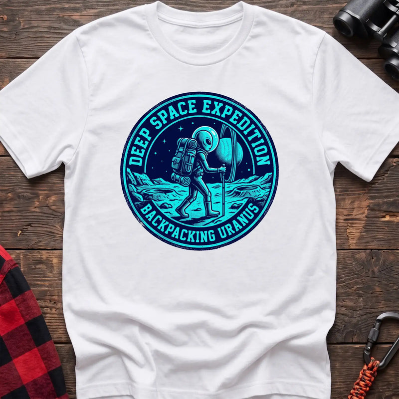 White t-shirt with circular badge graphic of an alien backpacking on Uranus, reading Deep Space Expedition Backpacking Uranus