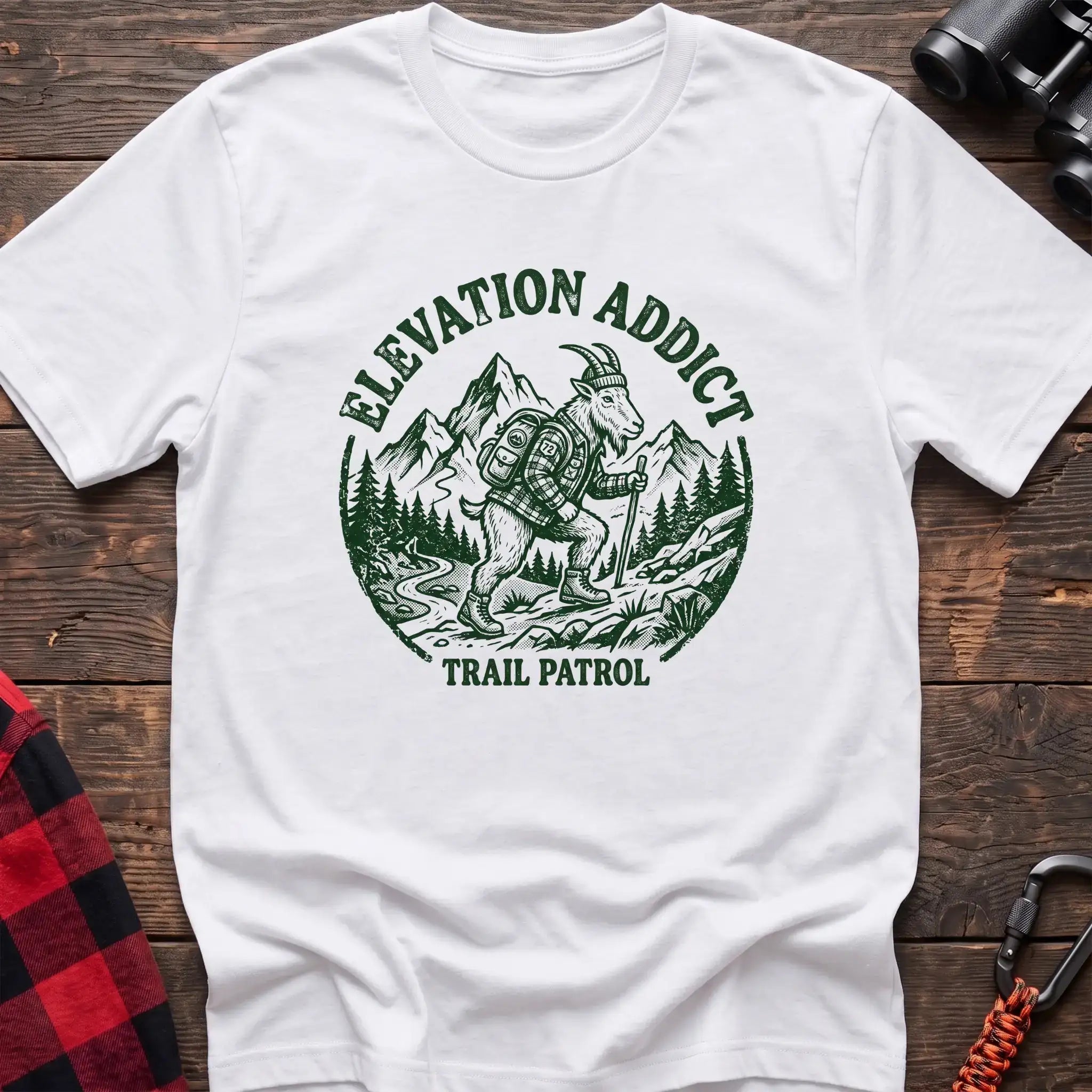 White t-shirt with circular graphic of a hiking mountain goat and the text Elevation Addict Trail Patrol
