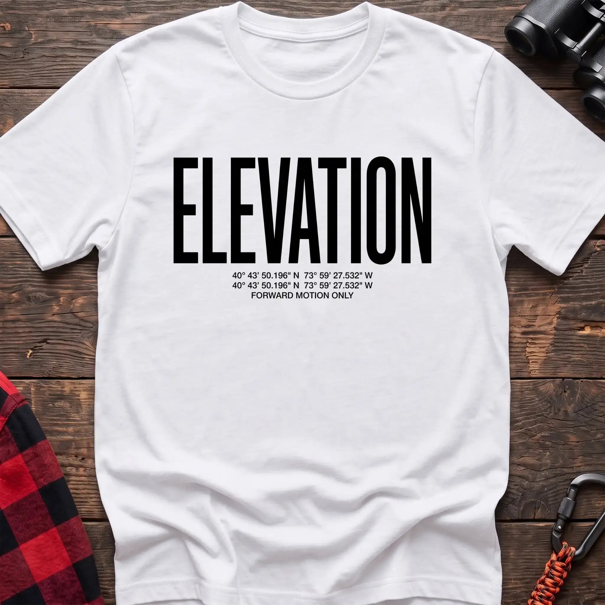 White t-shirt with large black text reading Elevation and GPS coordinates with Forward Motion Only