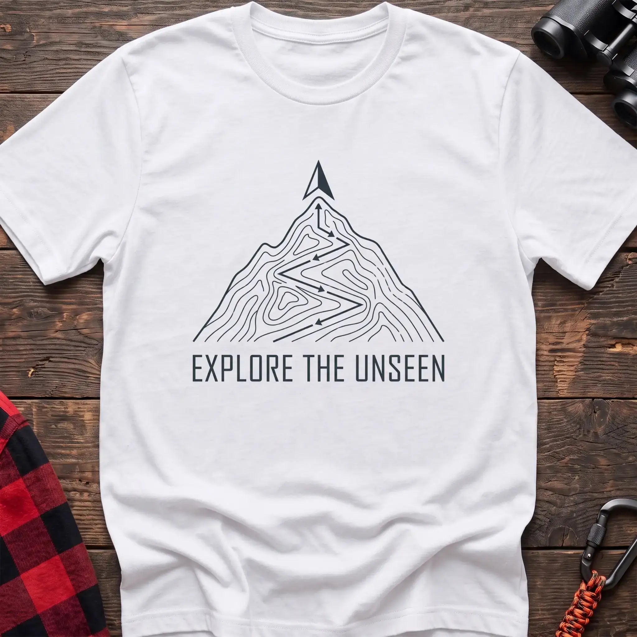 White t-shirt with topographic mountain trail graphic and the text Explore the Unseen