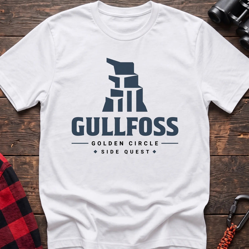 White cotton t-shirt with a stylized waterfall graphic and Gullfoss Golden Circle Side Quest text on rustic wood