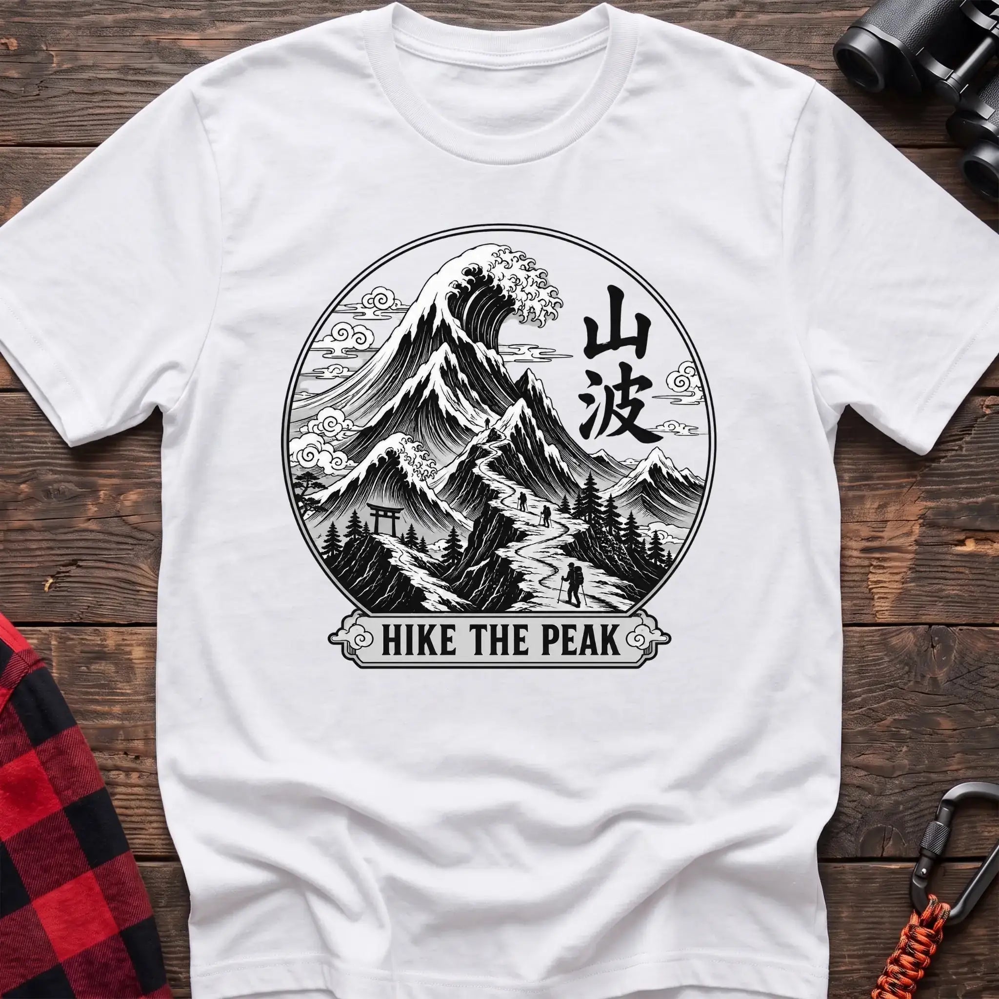 White t-shirt with circular Japanese-style mountain and wave graphic featuring hikers and the text Hike the Peak