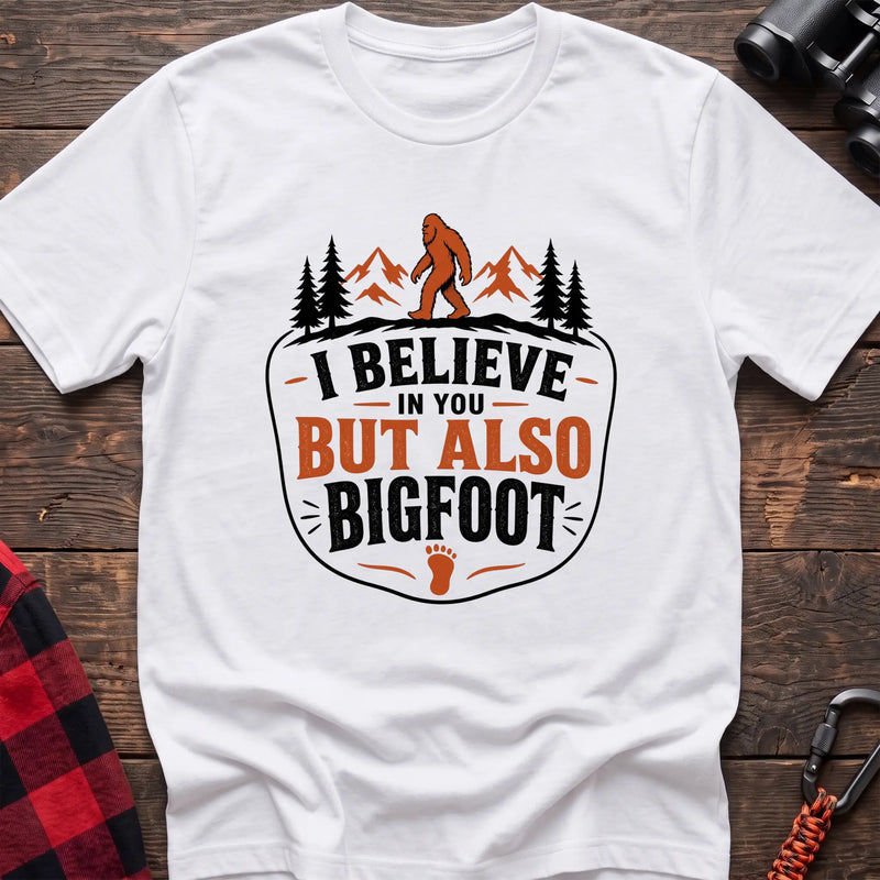White hiking t-shirt with Bigfoot on a mountain ridge and I Believe in You But Also Bigfoot text