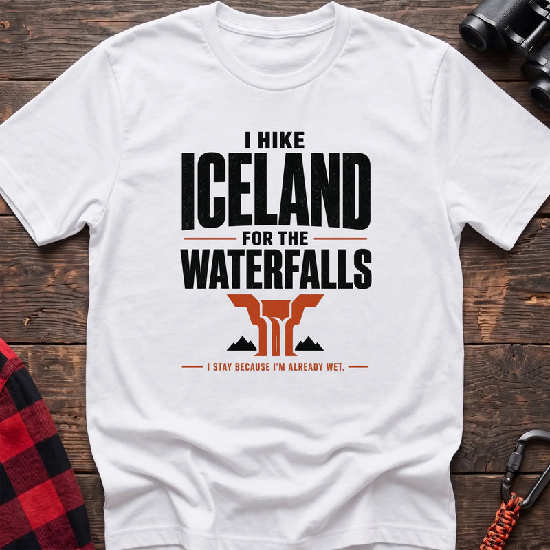White cotton t-shirt with a waterfall graphic and I Hike Iceland for the Waterfalls text on rustic wood