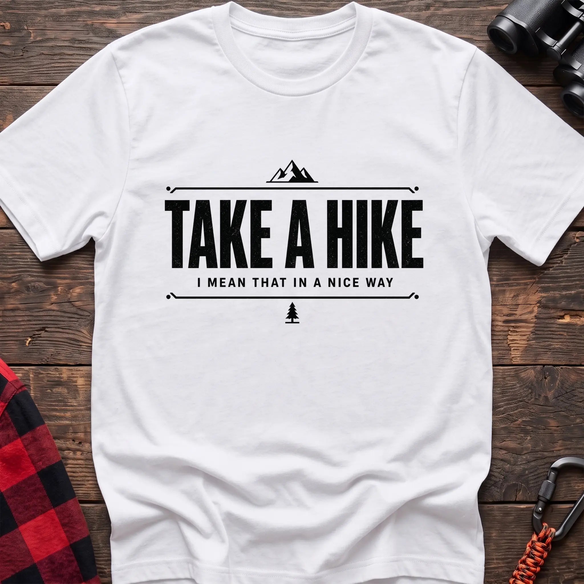 White cotton hiking t-shirt with "Take a Hike I Mean That in a Nice Way" quote, mountain icon, and pine tree graphic