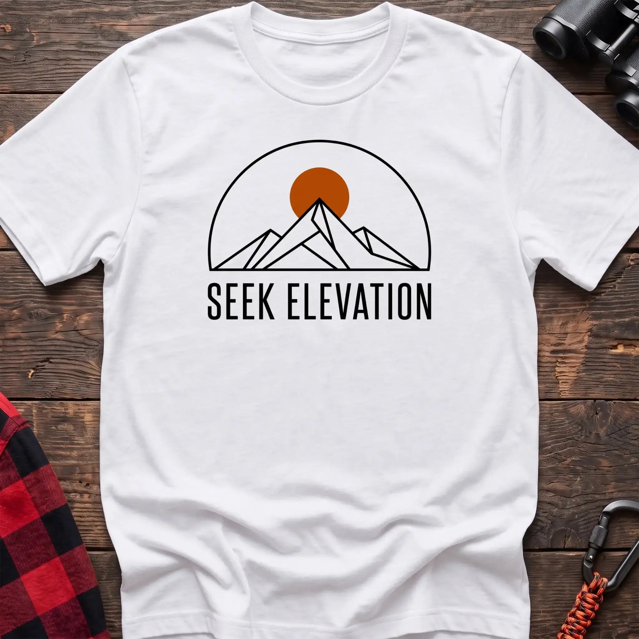 White t-shirt with minimalist mountain and sun graphic reading Seek Elevation