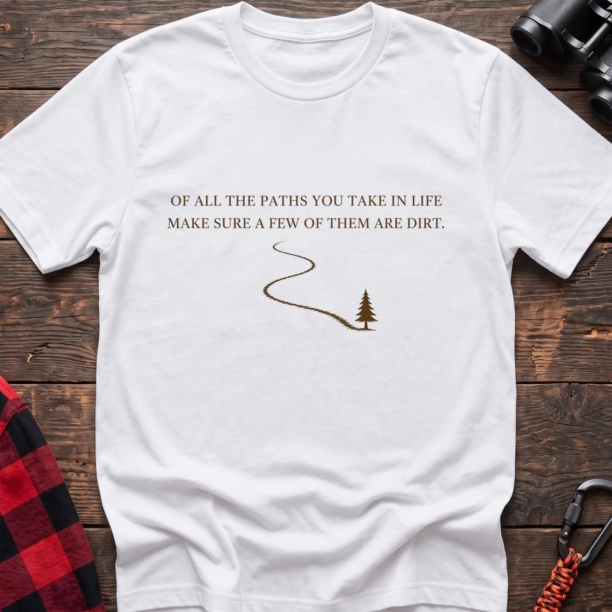 White cotton hiking t-shirt with white quote "Of all the paths you take in life make sure a few of them are dirt" and winding dirt path to pine tree graphic