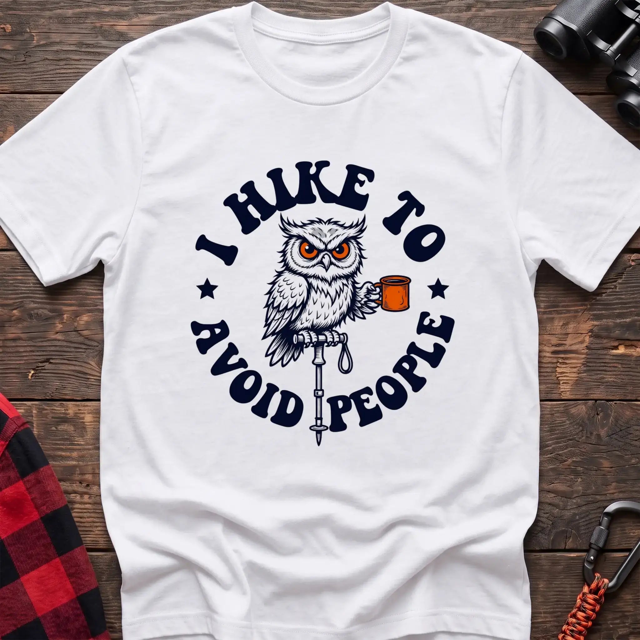 White t-shirt with owl holding a camping mug on a hiking pole and the text I Hike to Avoid People