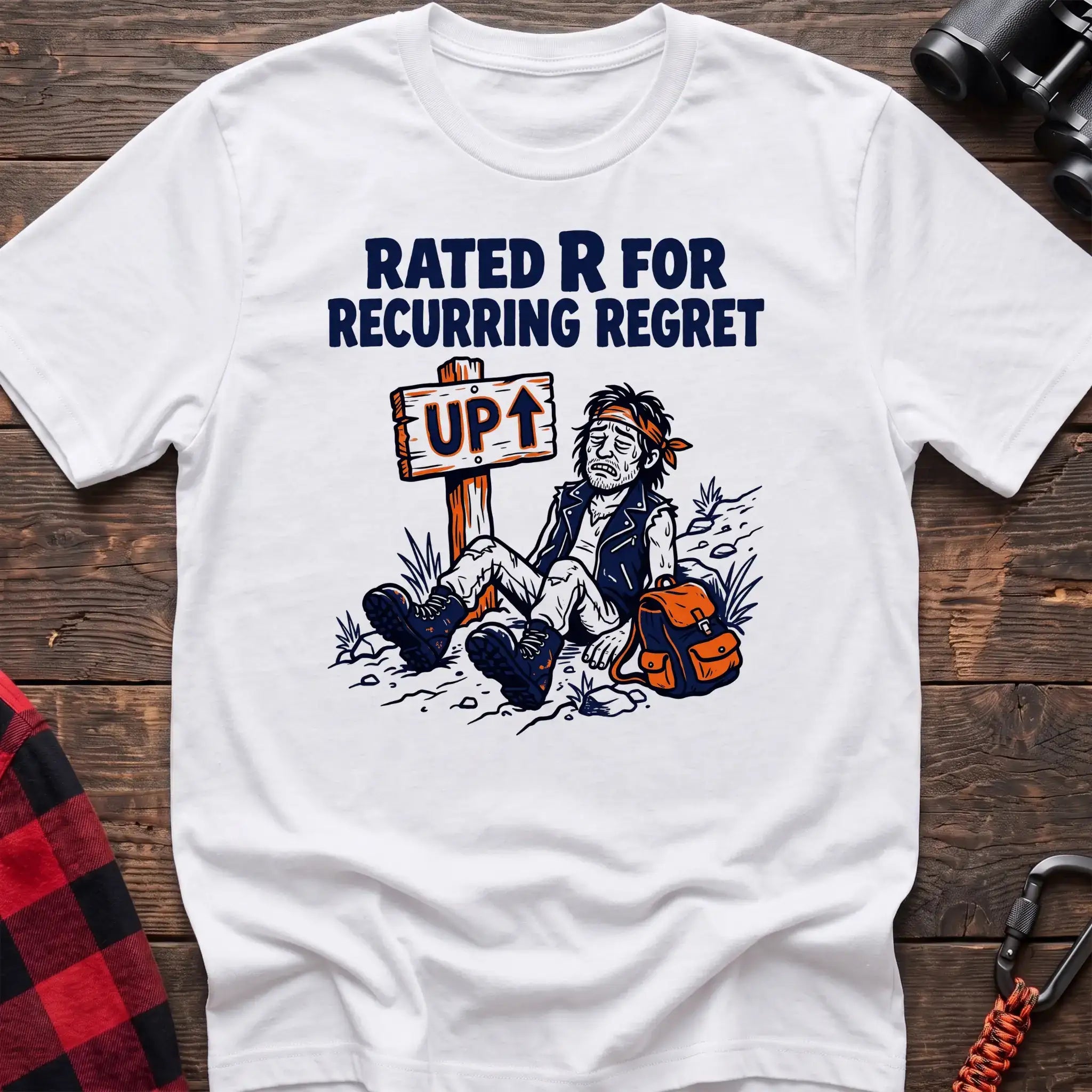 White t-shirt with illustration of an exhausted hiker sitting by an UP trail sign and the text Rated R for Recurring Regret