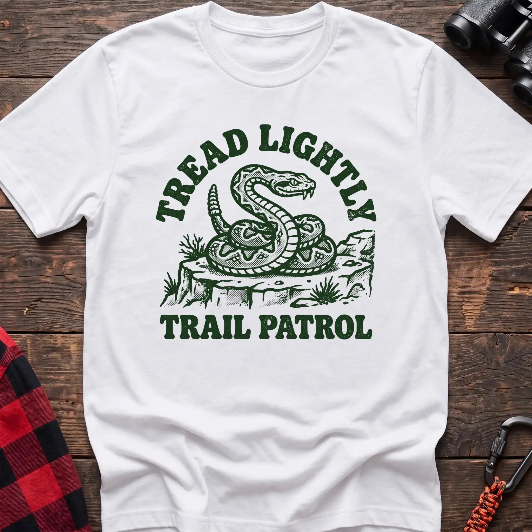 White t-shirt with dark green rattlesnake illustration and the text Tread Lightly Trail Patrol