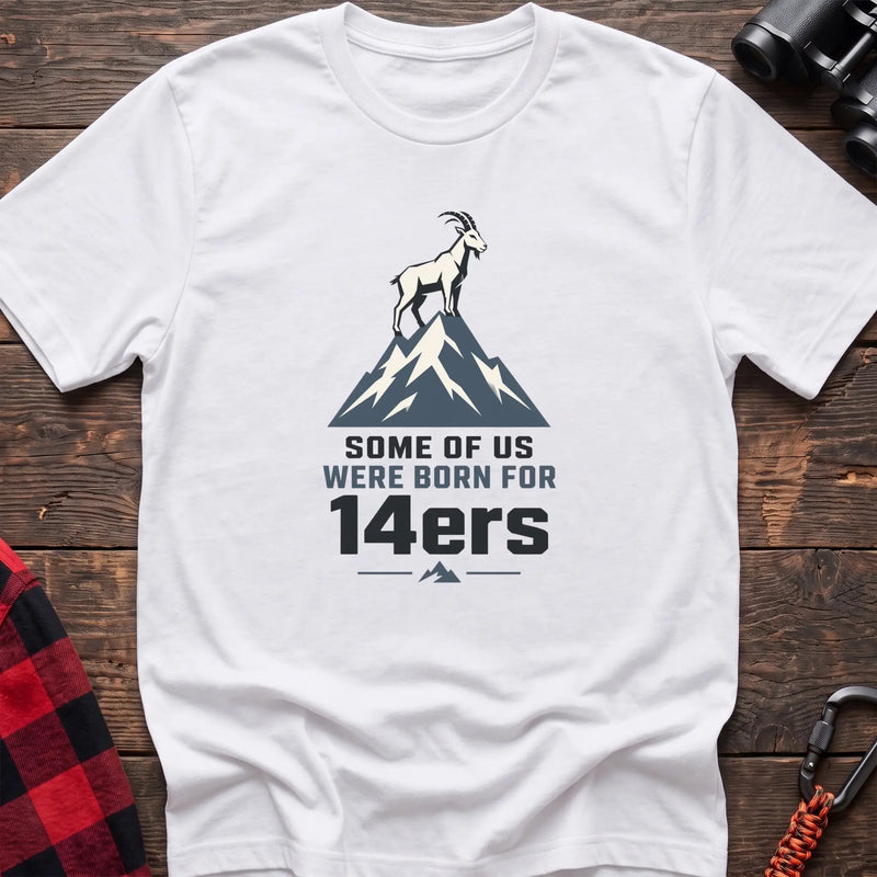 White hiking t-shirt with a mountain goat on a peak and the text “Some of Us Were Born for 14ers”
