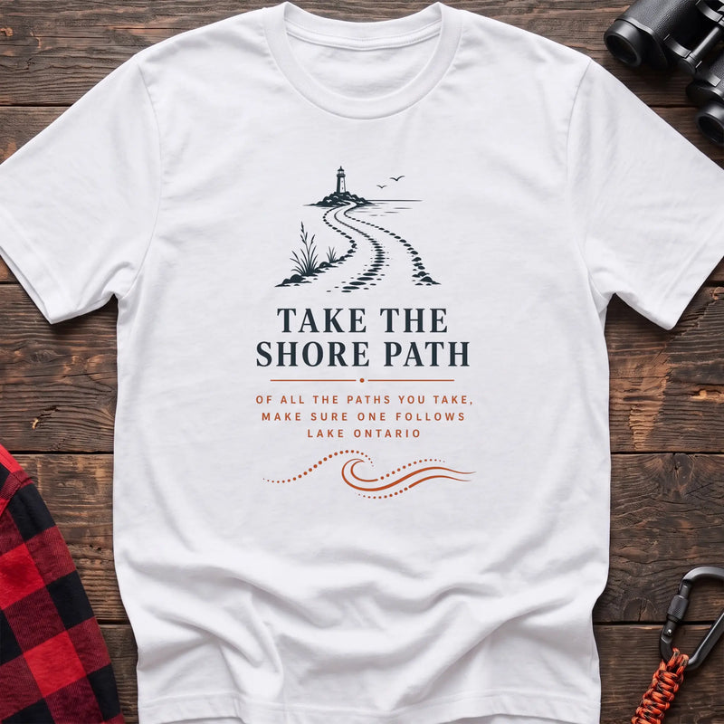 White cotton hiking t-shirt with lighthouse and winding shore path graphic and "Take the Shore Path – make sure one follows Lake Ontario" quote