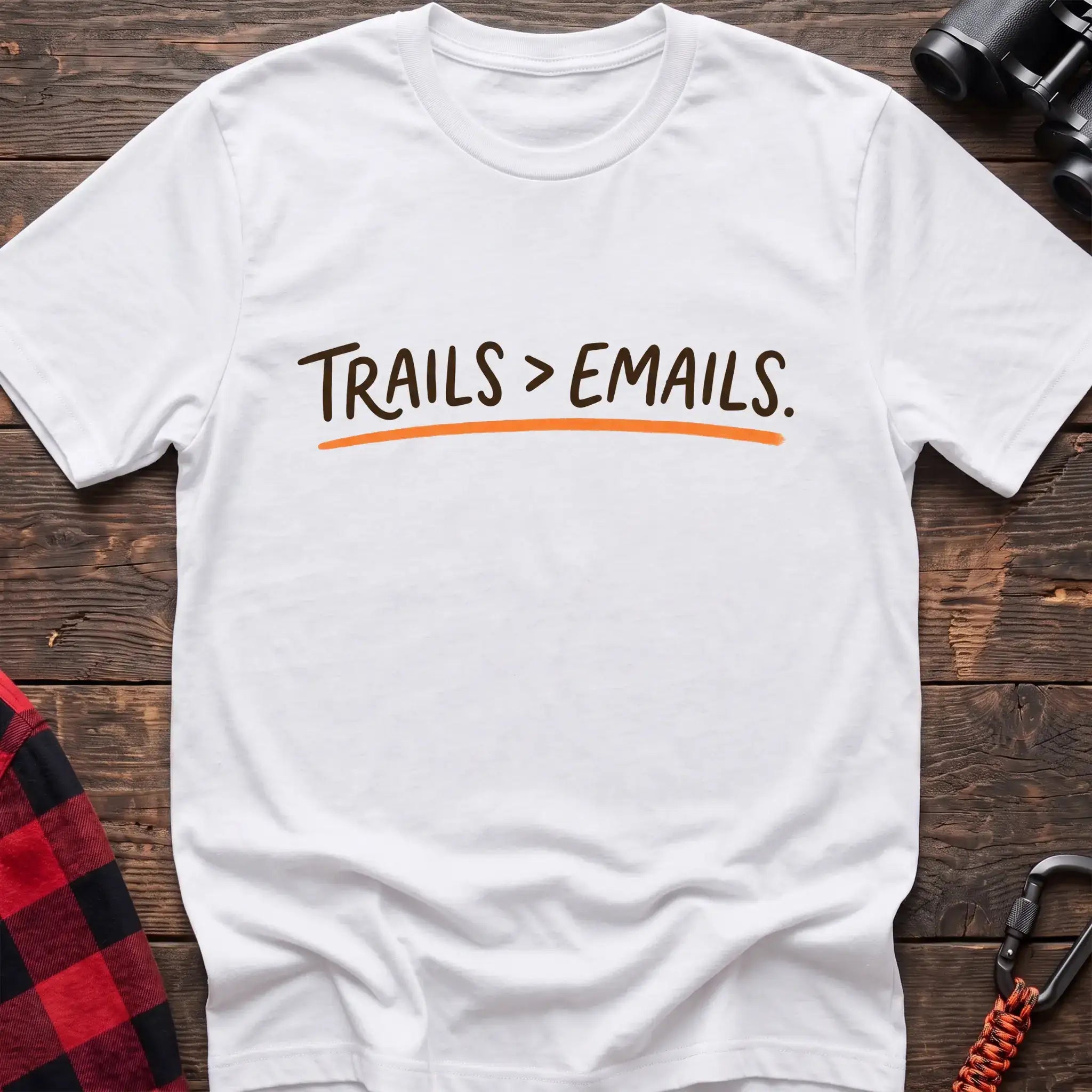 White t-shirt with brown handwritten-style text reading Trails greater than Emails and an orange underline