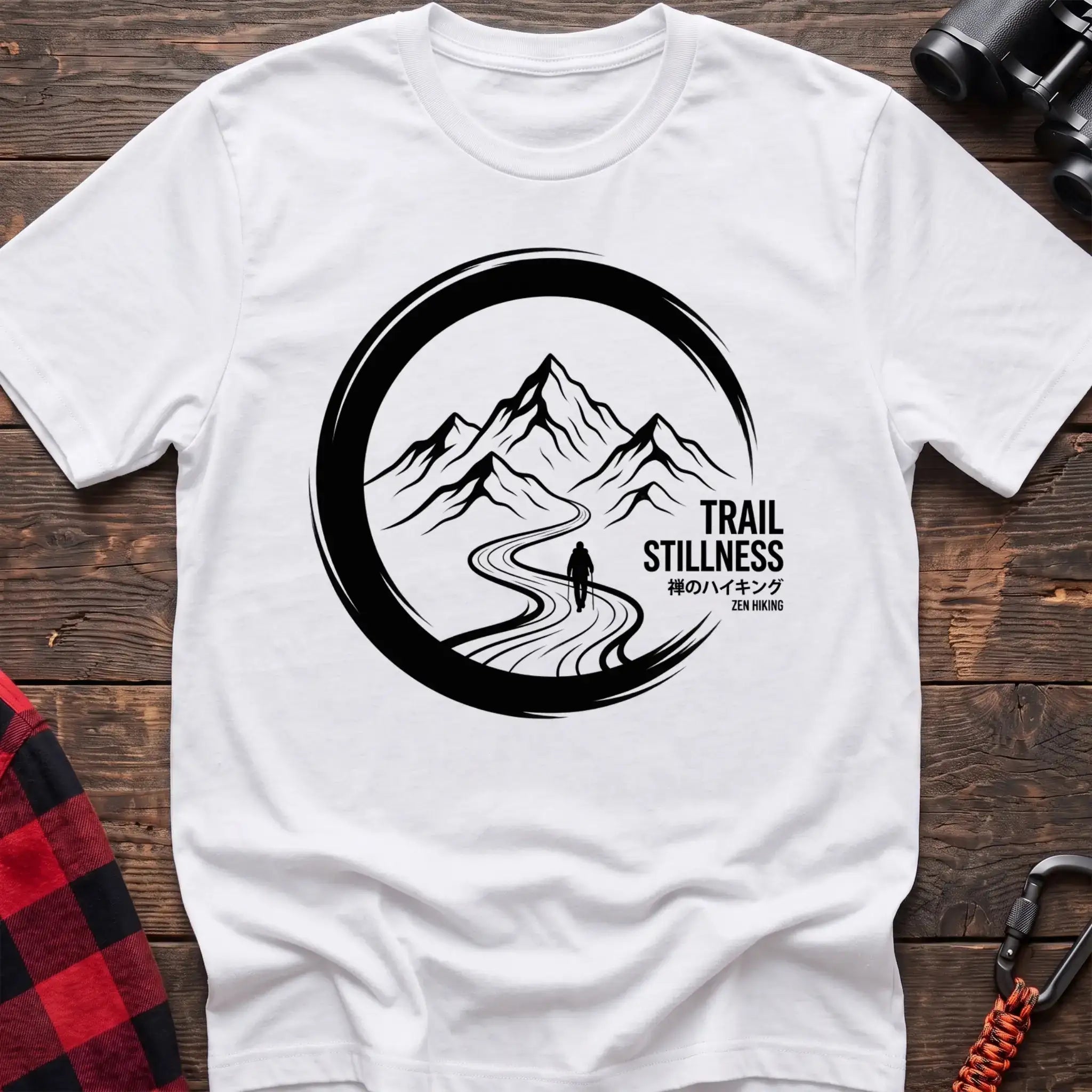 White t-shirt with circular mountain trail graphic of a hiker and the text Trail Stillness Zen Hiking