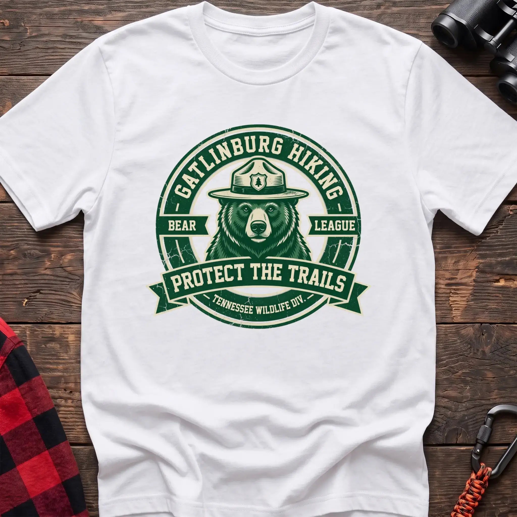 White t-shirt with circular badge of a bear in a ranger hat reading Gatlinburg Hiking Bear League Protect the Trails